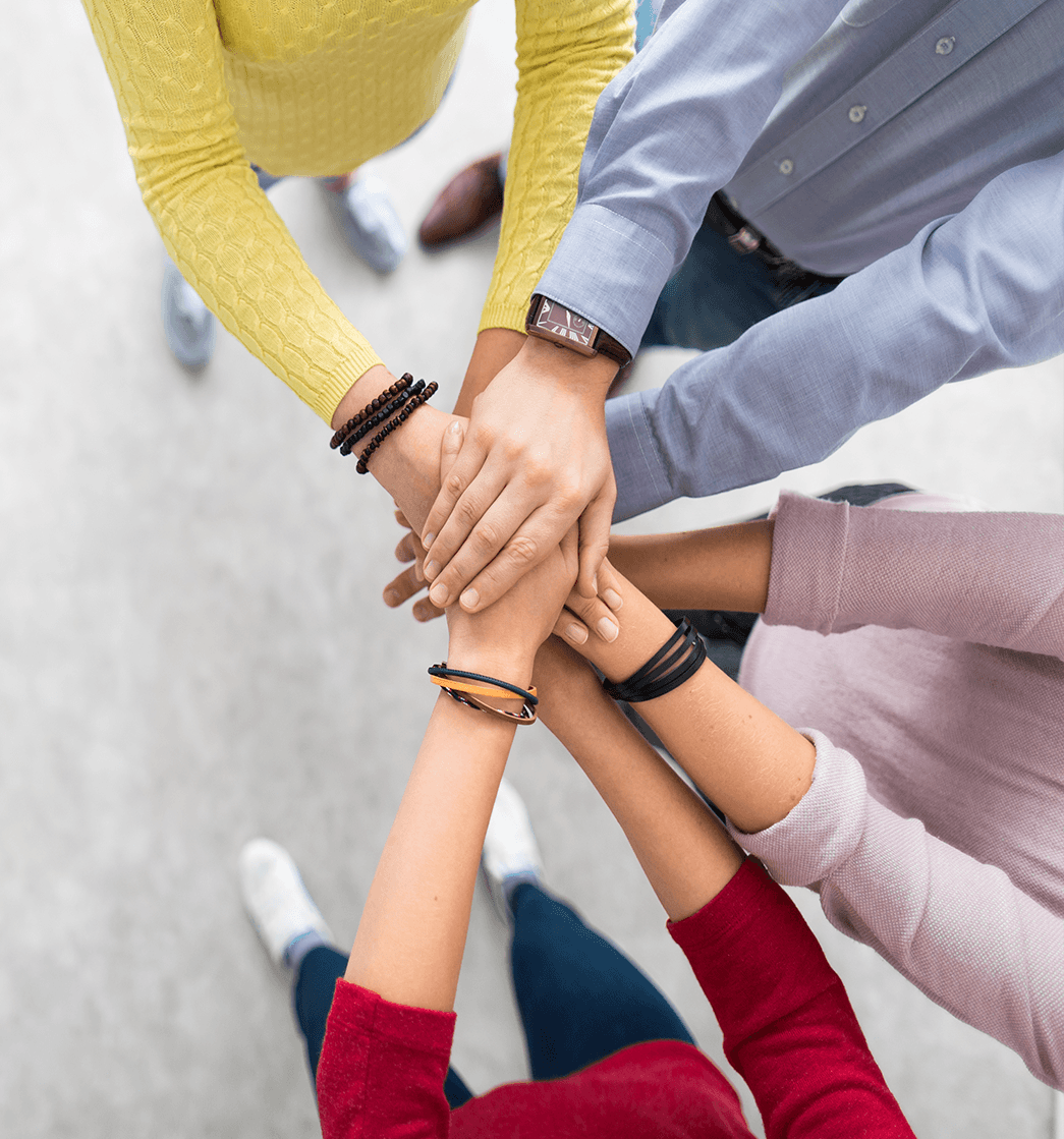 Hands joined together by different people